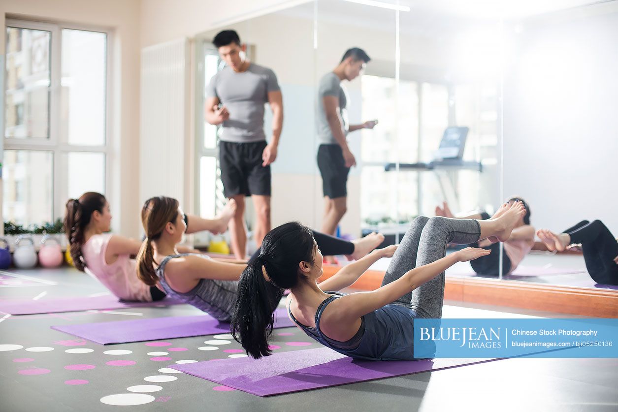 Young Chinese women exercising at gym