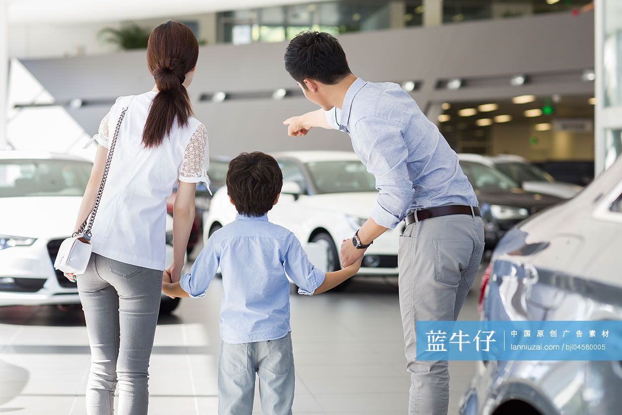 年轻家庭在4S店挑选汽车