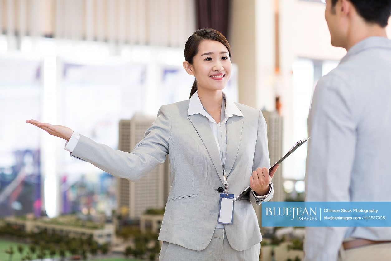 Confident Chinese realtor talking with customer-High-res stock photo ...