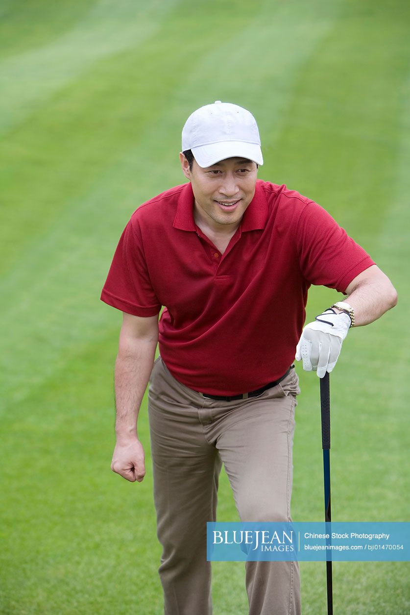 Portrait of a male Chinese golfer on the course