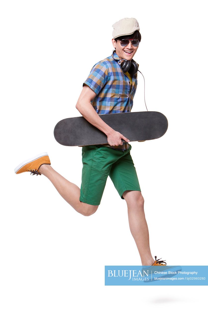 Cool young Chinese man with skateboard