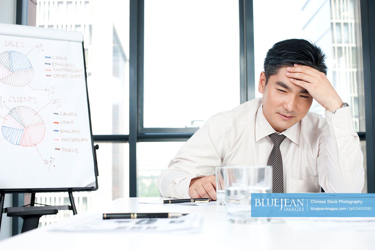 Chinese business executive focusing on document
