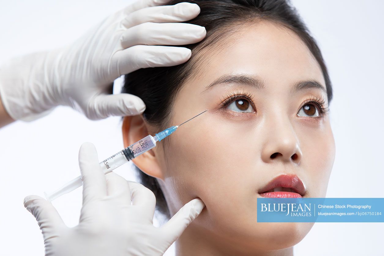 Young Chinese woman receiving Botox treatment