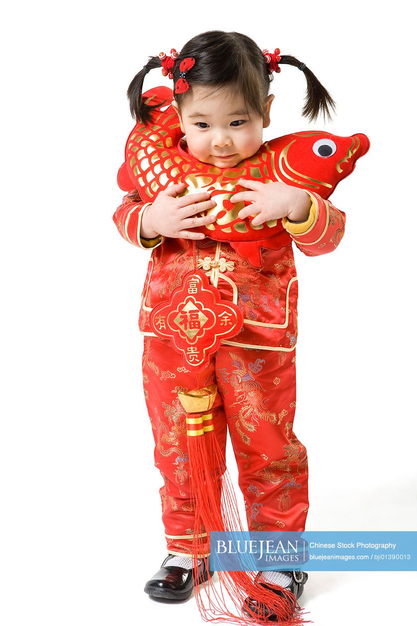 Young girl holding Chinese New Year fish