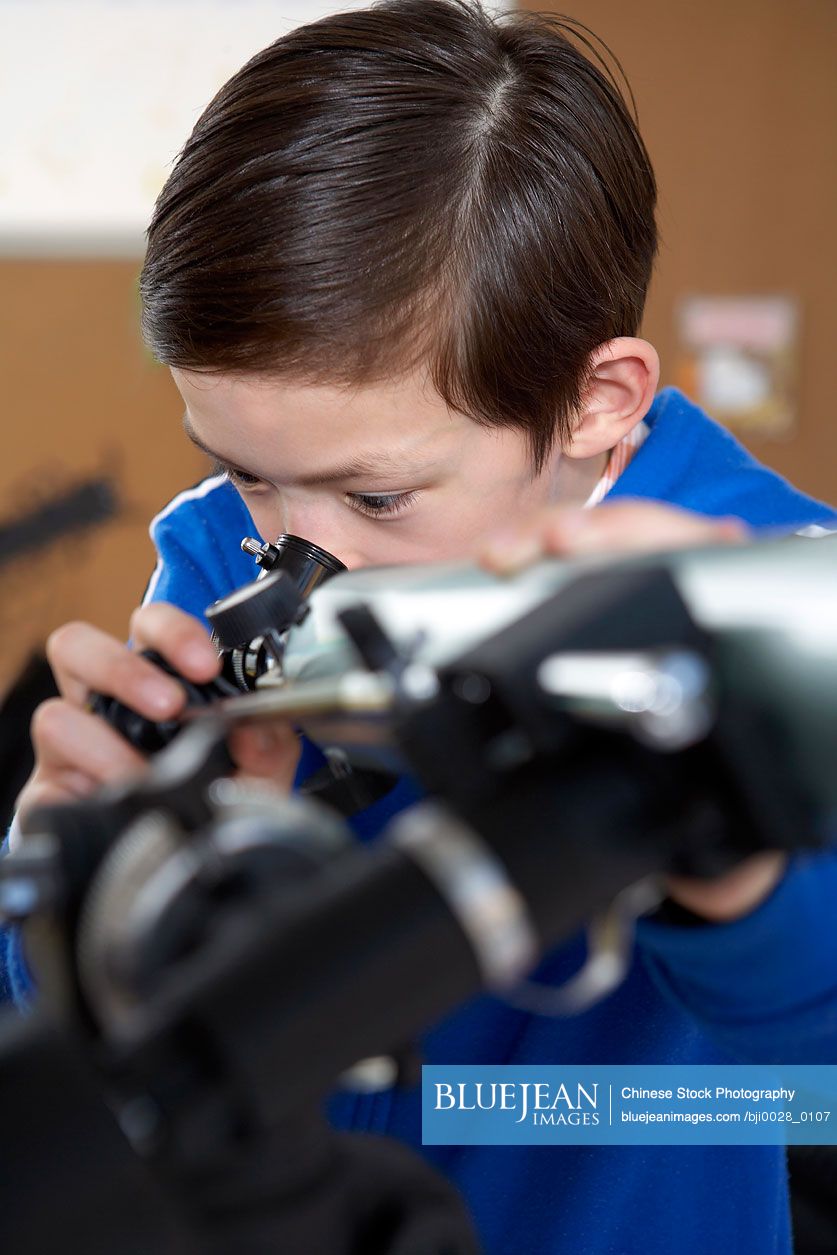 Boy looking through telescope