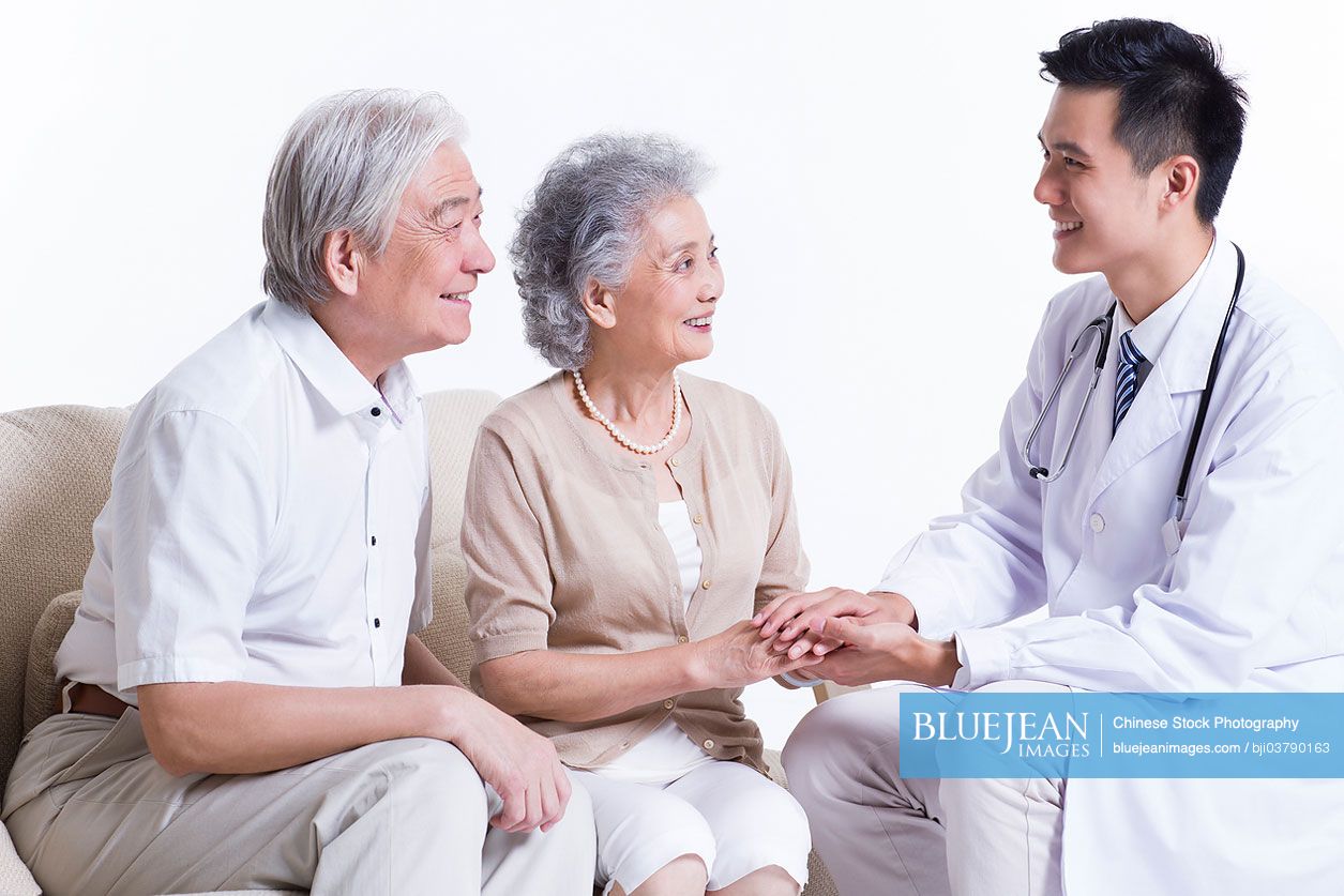 Chinese doctor talking with senior couple
