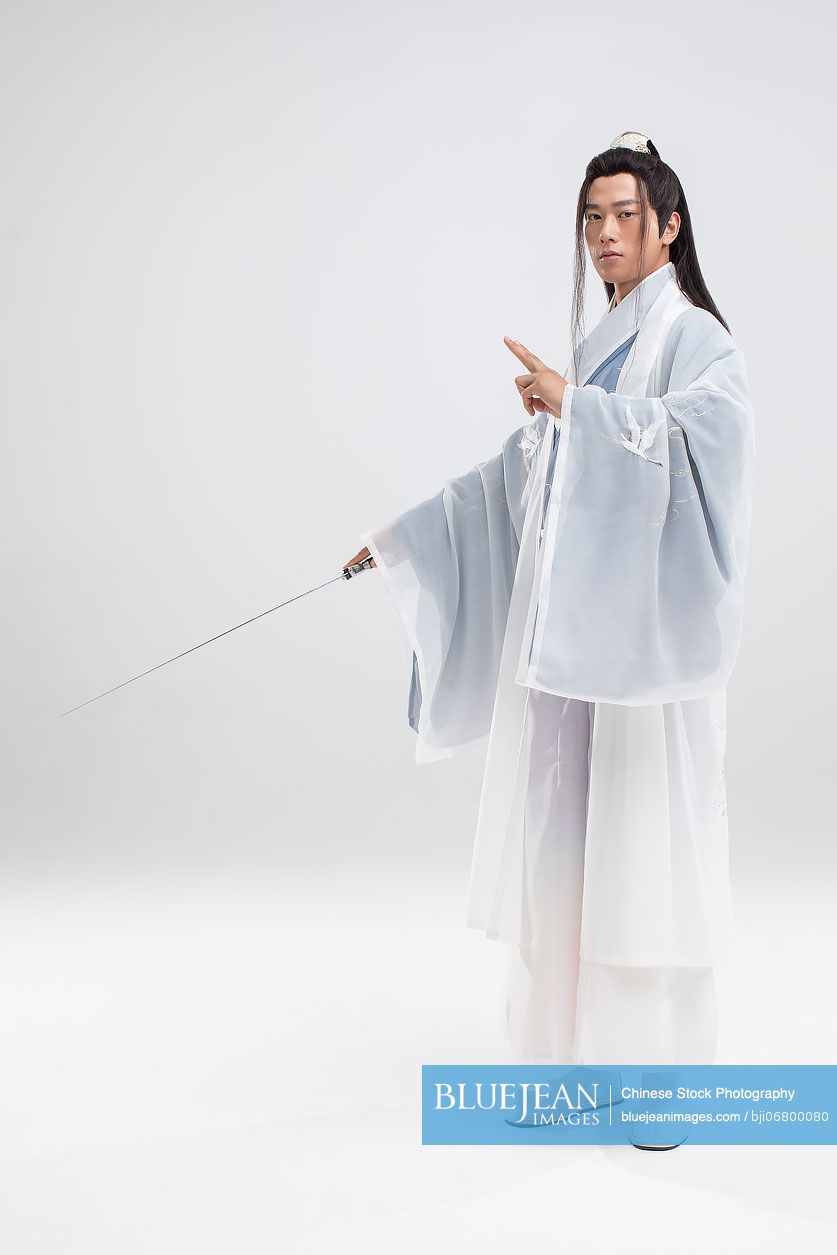 Young Chinese swordsman in ancient costume