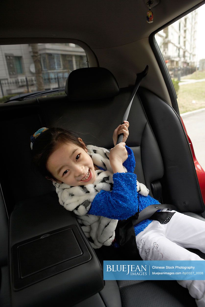 Young Chinese Girl Pulling Seatbelt In Car