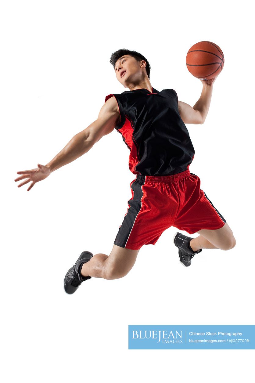Chinese man jumping to shoot basketball