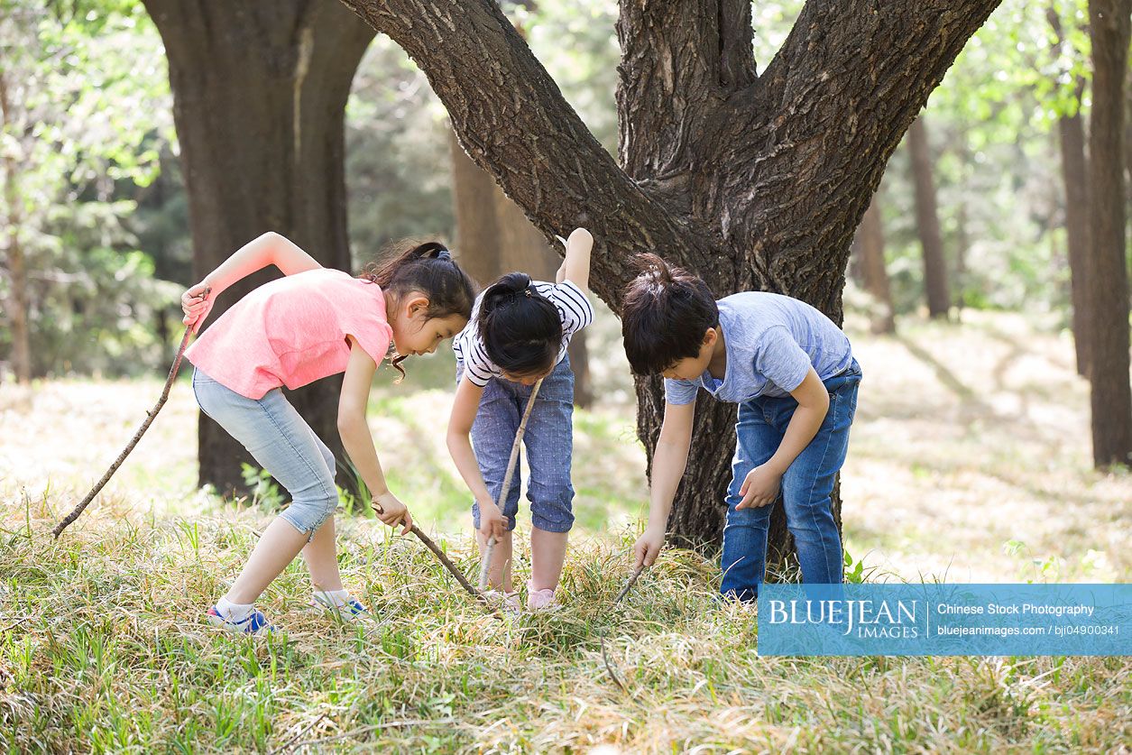 Happy Chinese children playing in woods