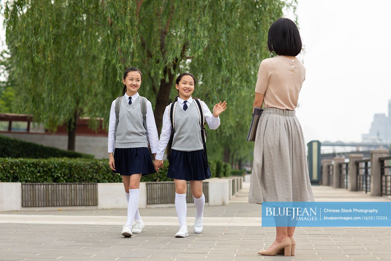 Chinese students waving to teacher