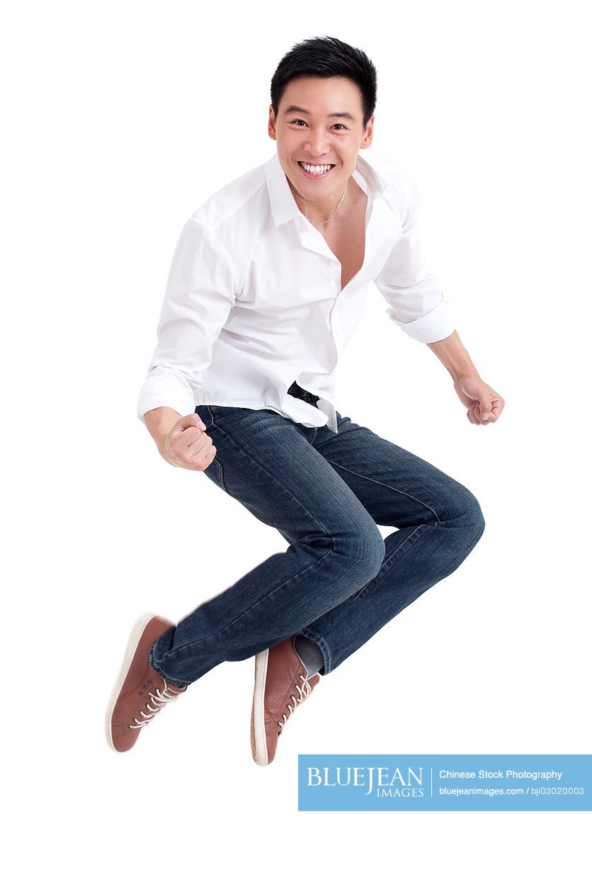 Young Chinese man jumping in mid air