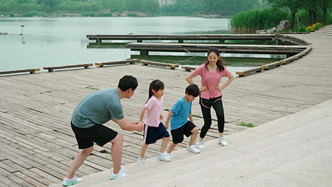 A young family works out in the park, staying active and healthy