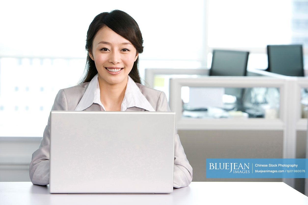 Chinese office worker at her desk