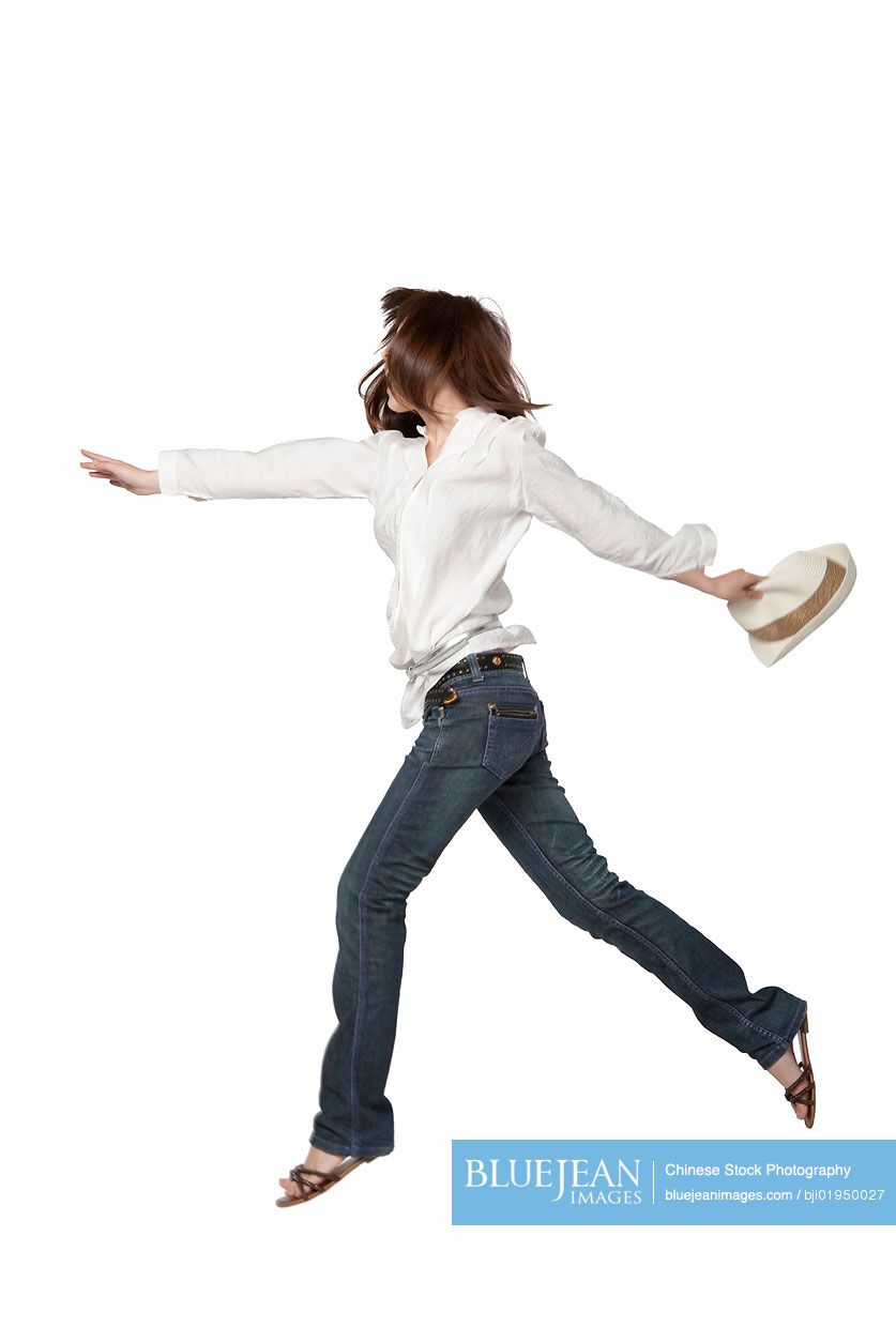 Portrait of young Chinese woman jumping