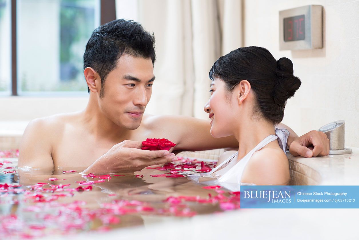 Young Chinese couple in love enjoying hot bath