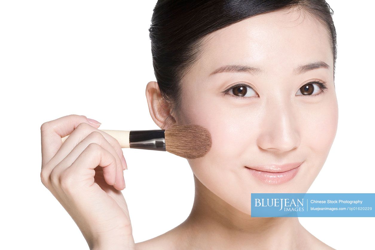 beauty-shot-of-a-young-chinese-woman-with-a-blusher-high-res-stock