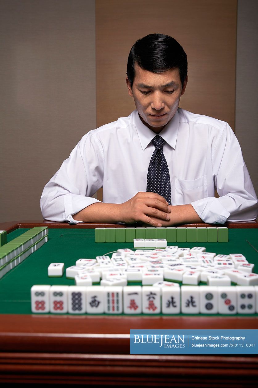 A Chinese businessman plays Mahjong