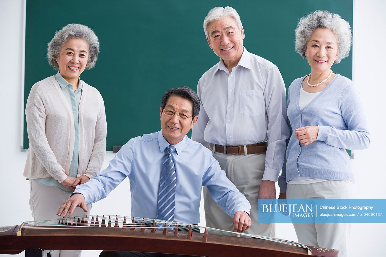 Senior Chinese adults having music class at school