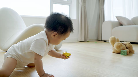 Baby playing with building blocks on the floor