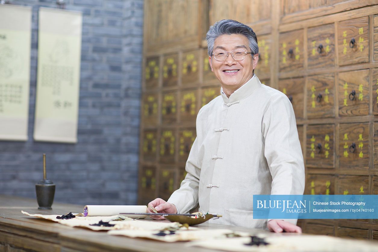 Senior Chinese doctor with various medicinal herbs