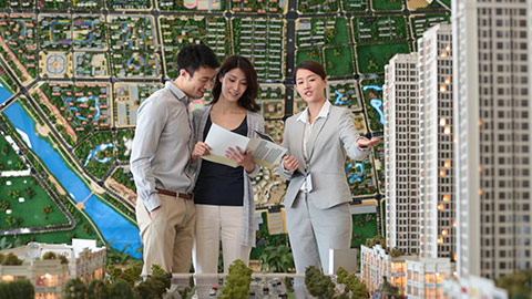 Young Chinese realtor showing architectural model to young couple,HD