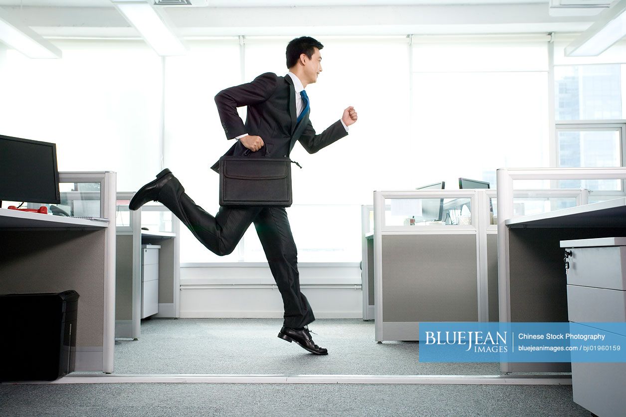 Chinese office worker running around in the office