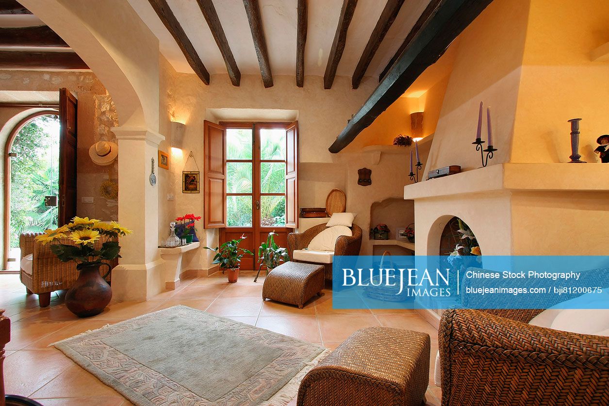 Spanish style living room with ceiling beams and fireplace