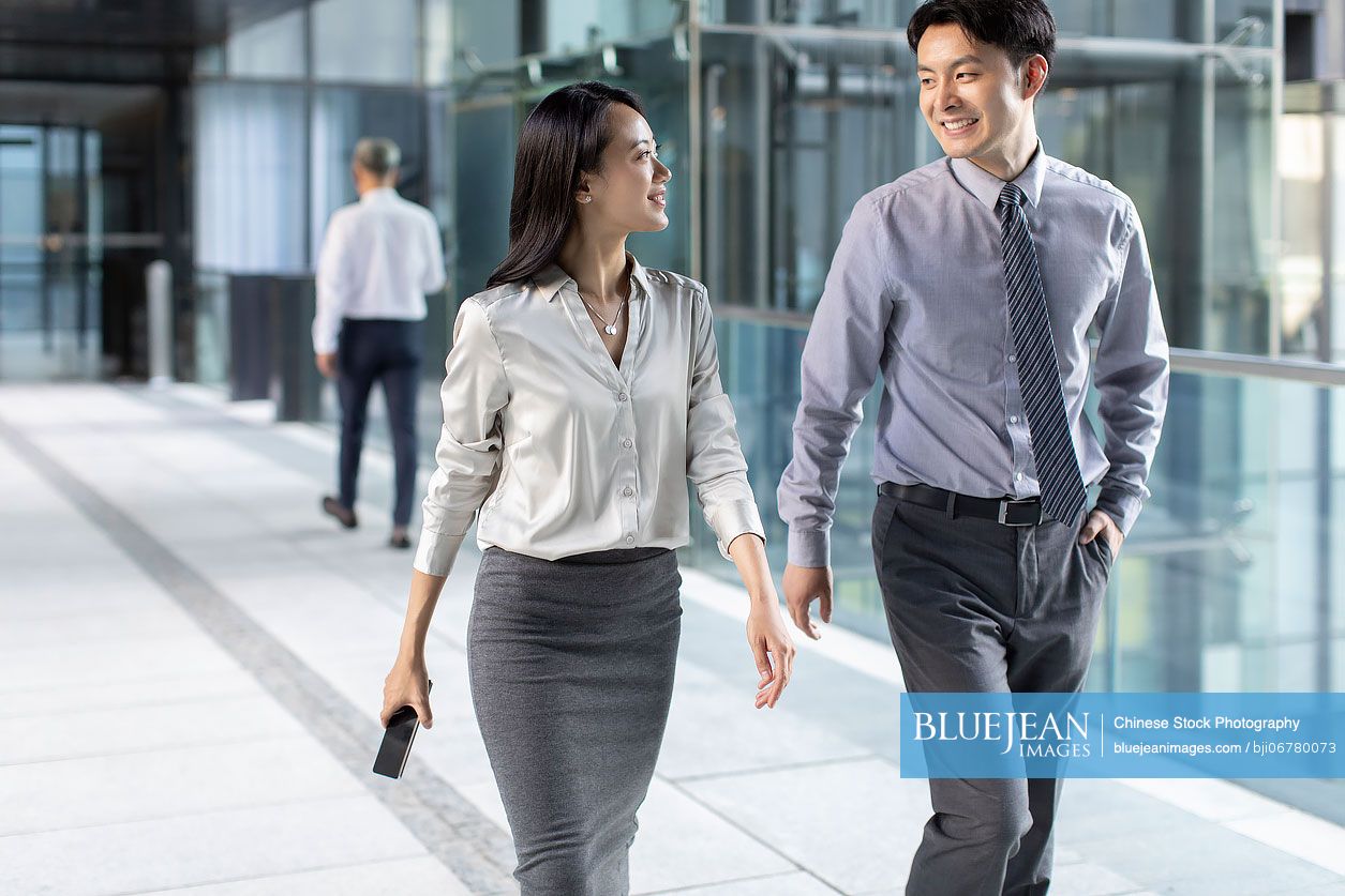 Confident Chinese business people walking