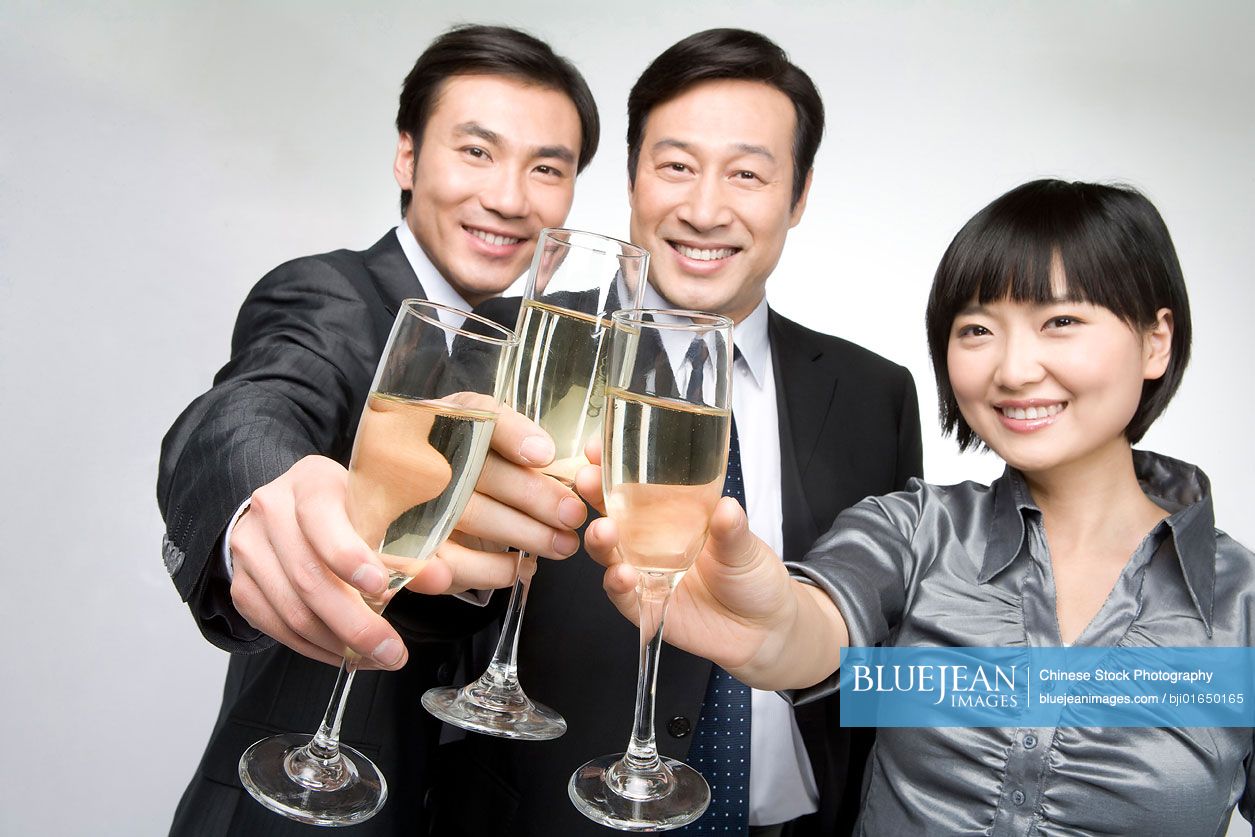 Chinese business team toasting with champagne