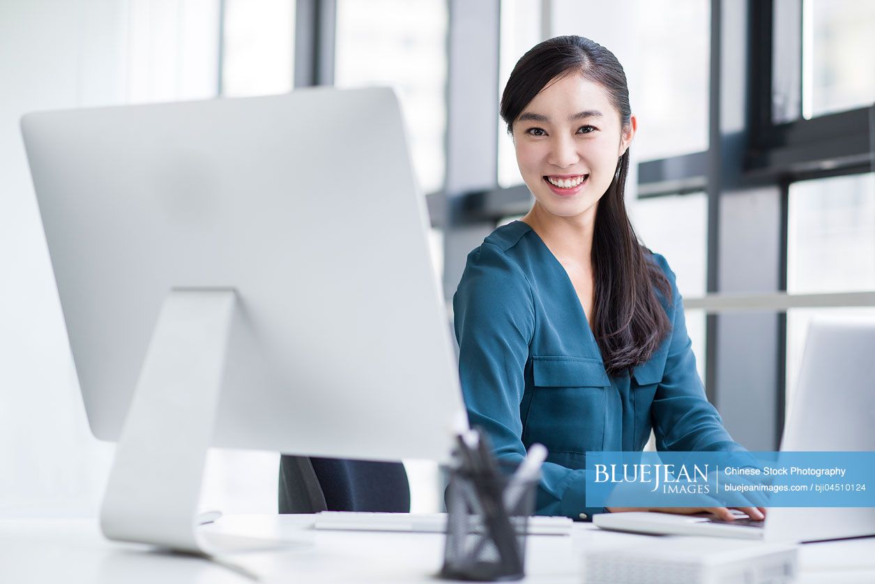 Young Chinese businesswoman working in office