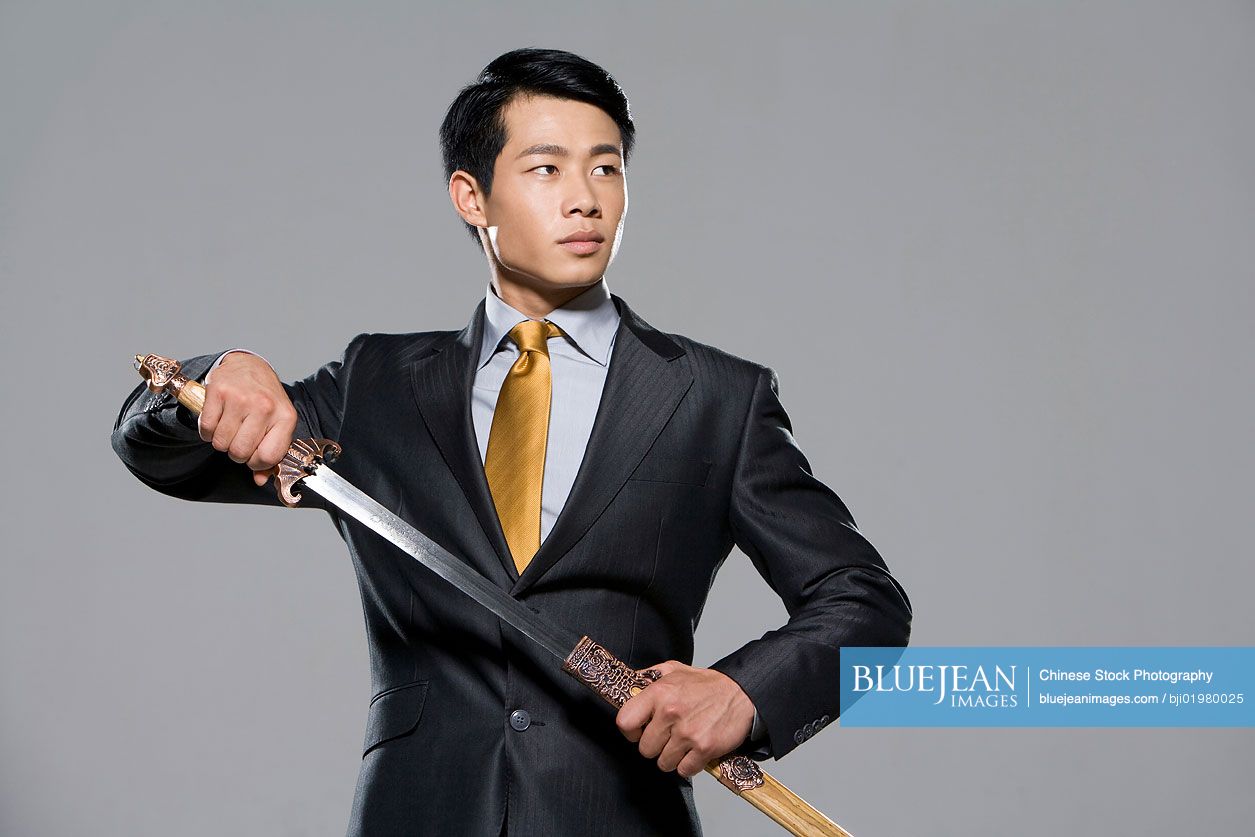 Chinese businessman holding a sword