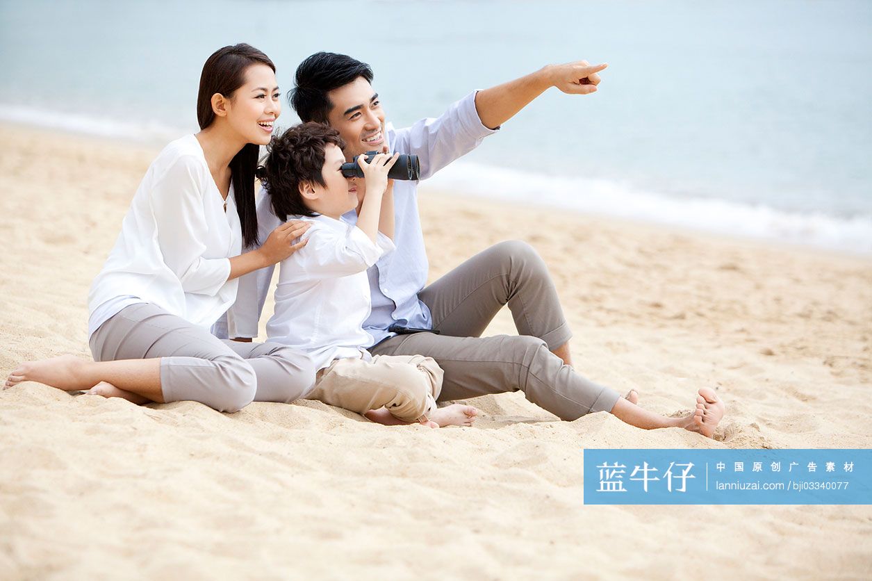 快乐一家人在沙滩上用望远镜看远方