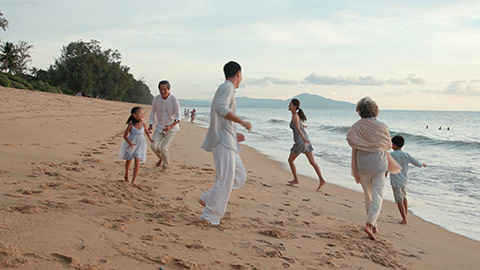 Happy Chinese family having fun on beach,4K