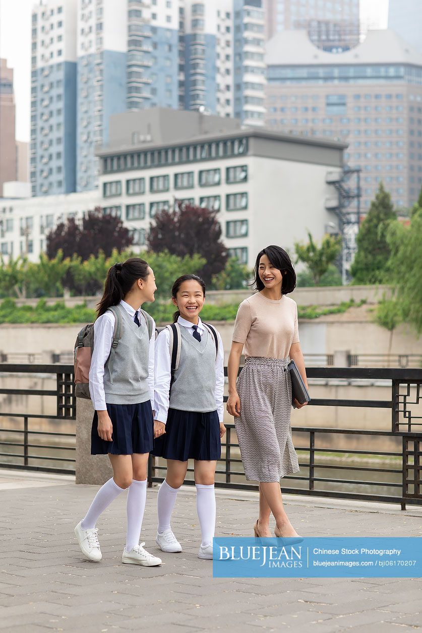 Chinese teacher talking with student on campus