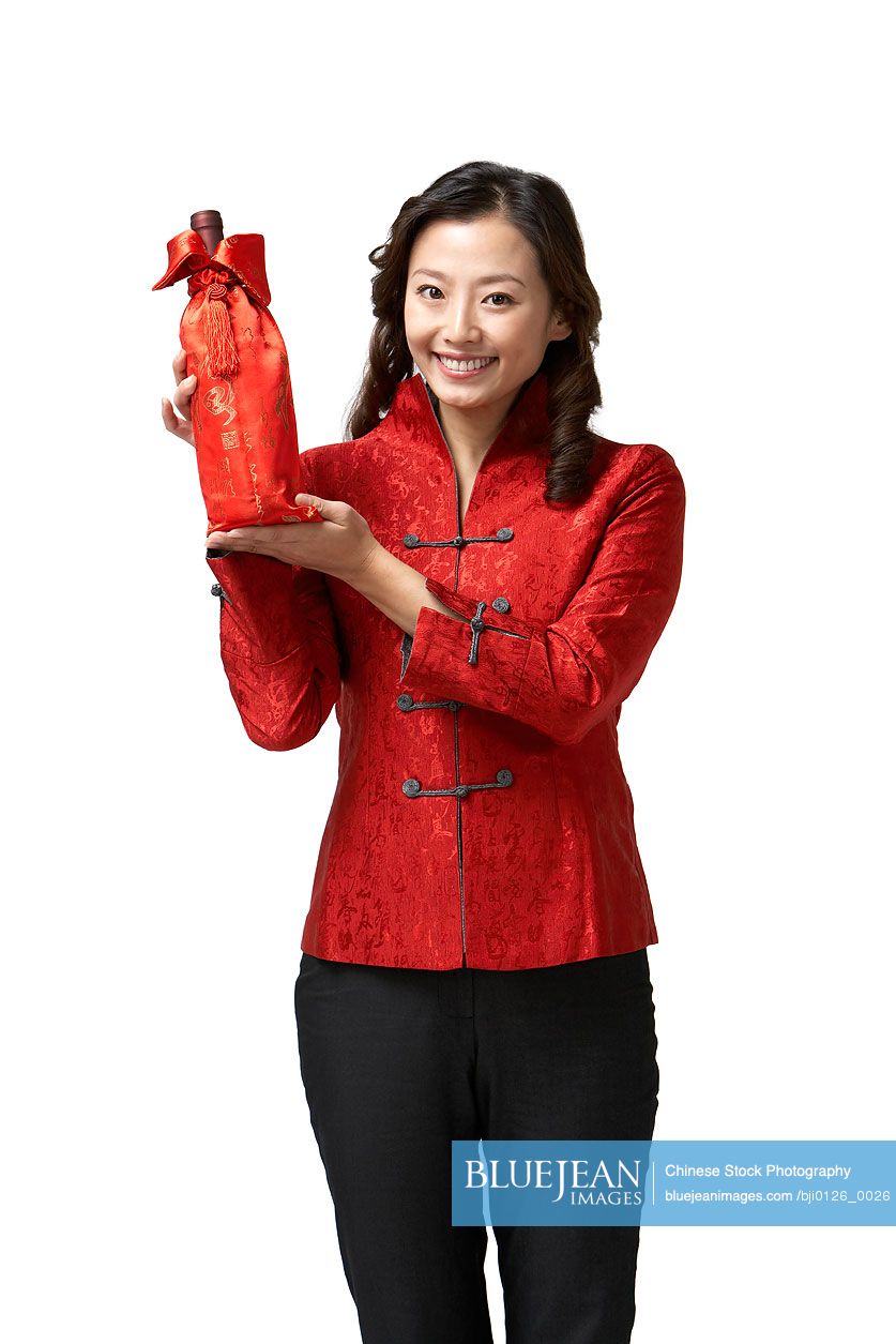 Young Chinese woman holding wine for Chinese New Year