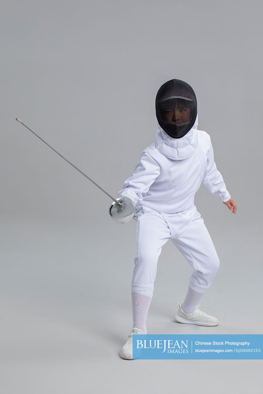 Cute Chinese boy in fencing suit