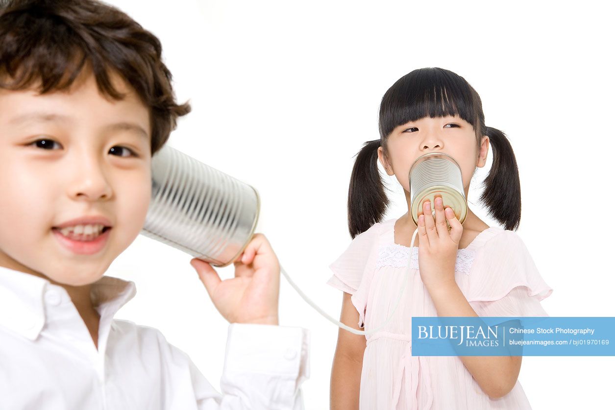 Chinese kids playing with a tin-phone