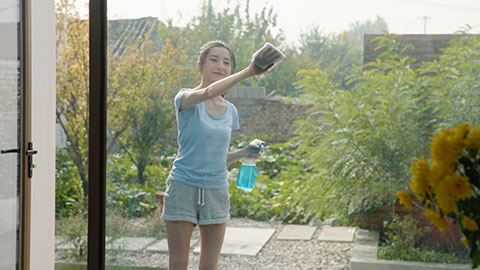 Cheerful young Chinese woman doing housework,4K