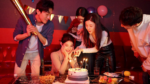 Young friends having fun at birthday karaoke party