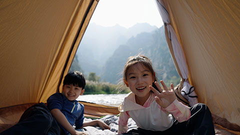 Cute Chinese Children relaxing in tent