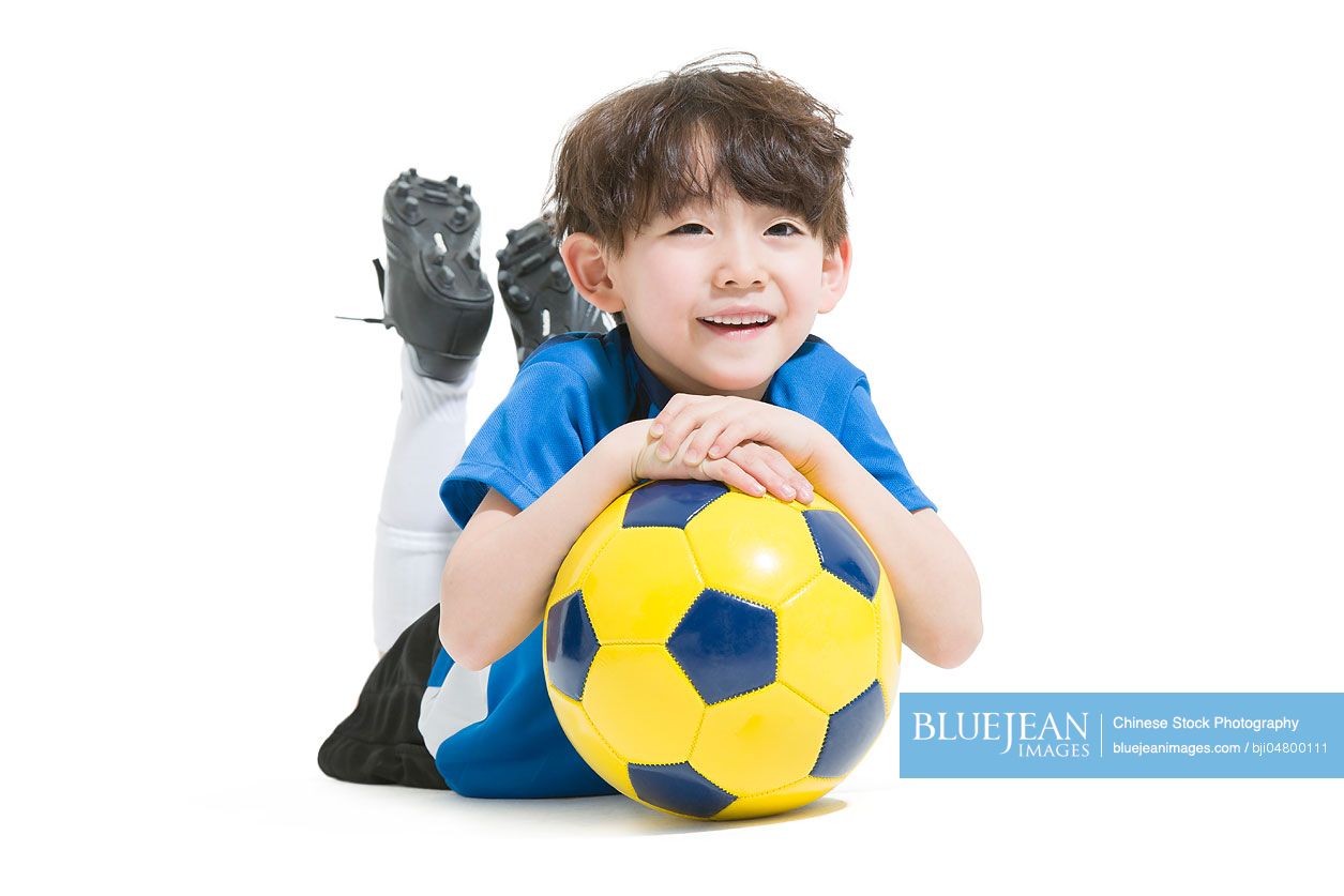 Cute Chinese boy and soccer ball
