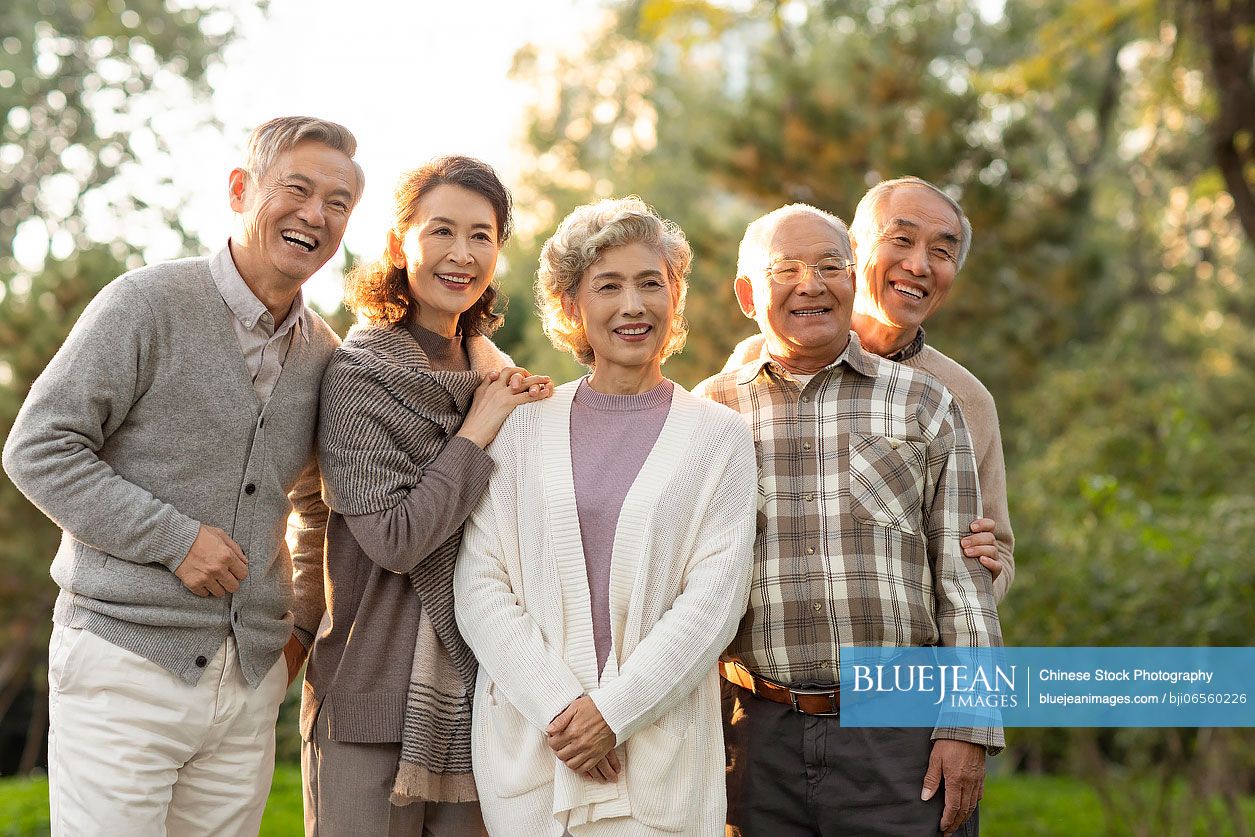 Cheerful senior Chinese adult relaxing in the park