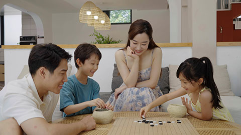 Family enjoying a game of Go in the hotel room