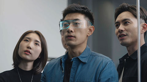 Confident Chinese designers checking futuristic glasses,4K