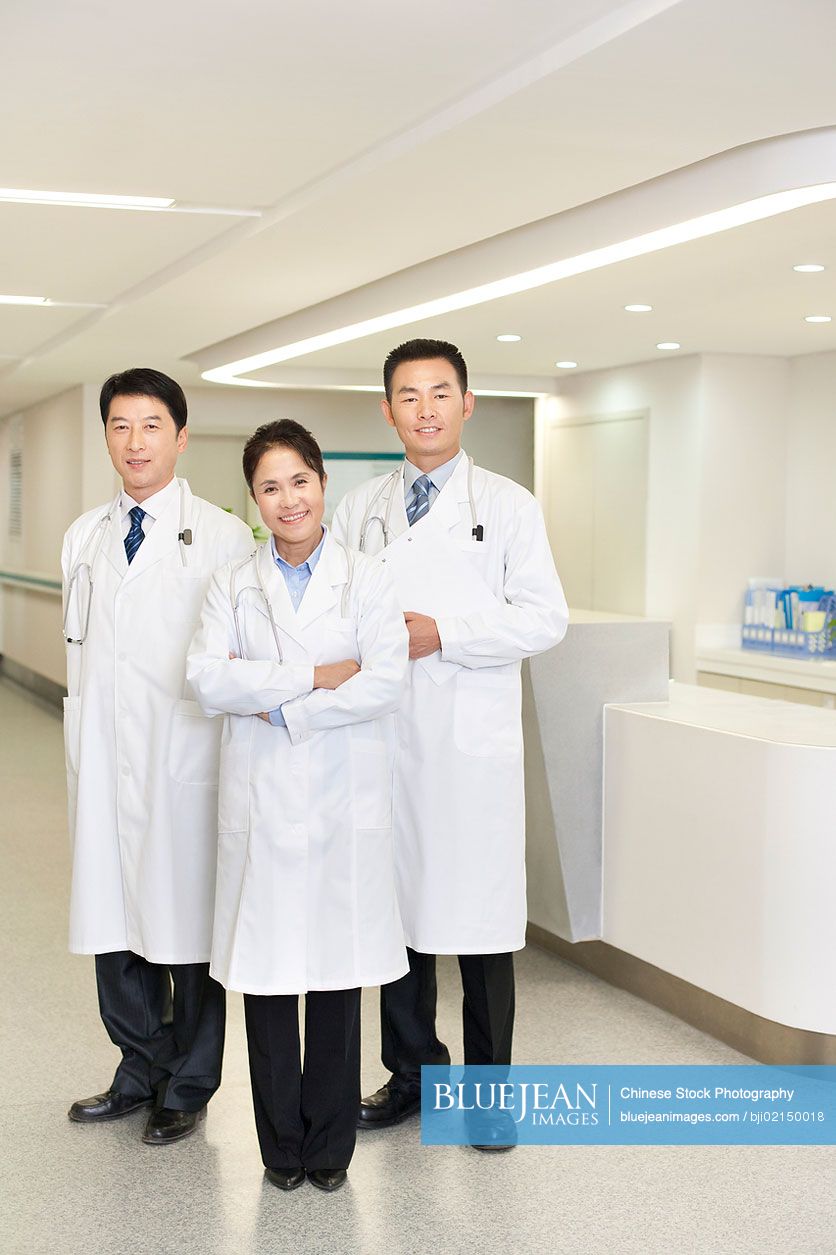 A team of smiling Chinese doctors