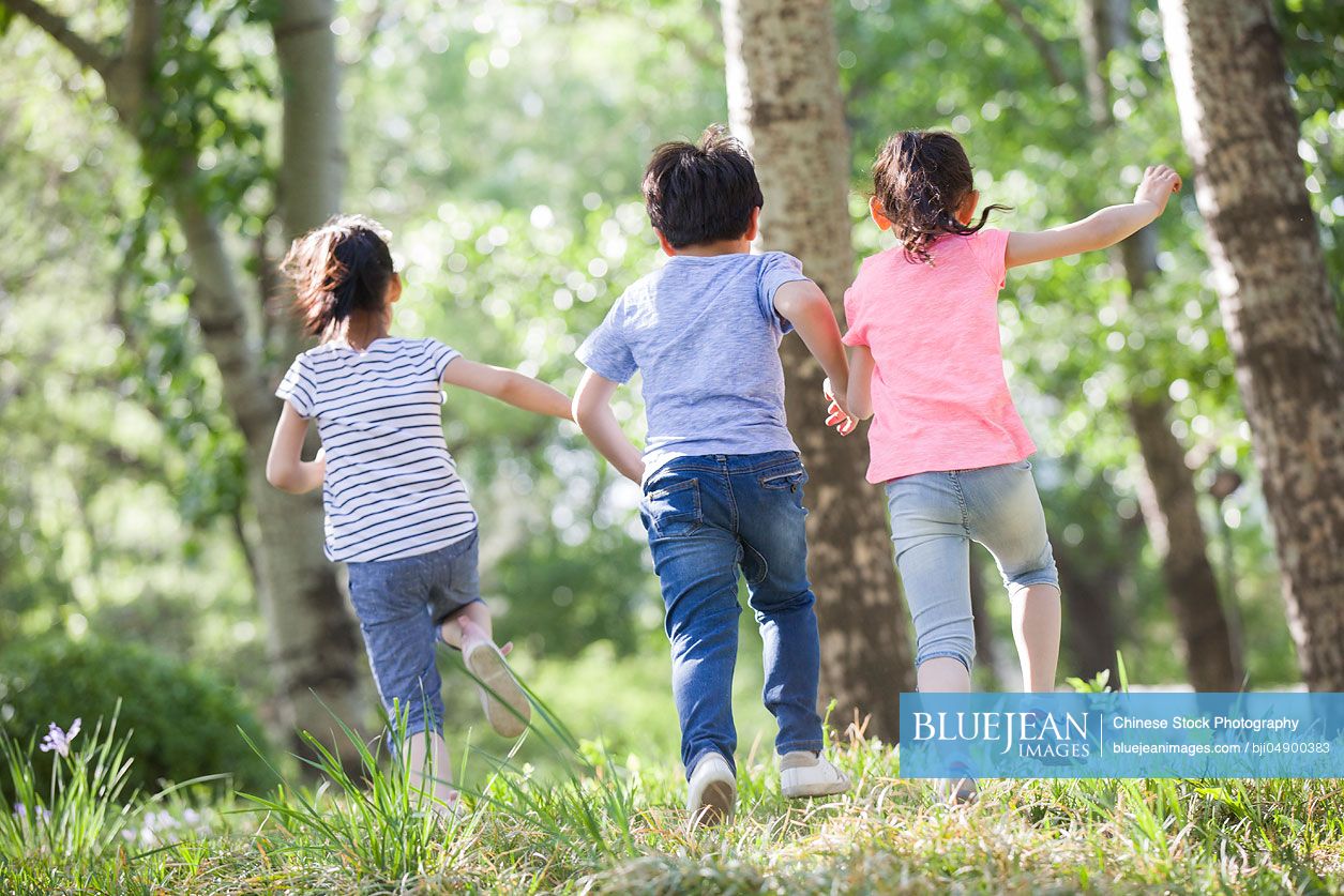 Happy Chinese children racing in woods