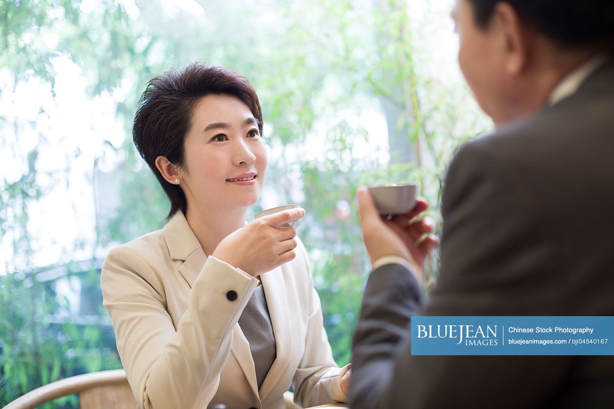 Chinese business person discussing in tea room