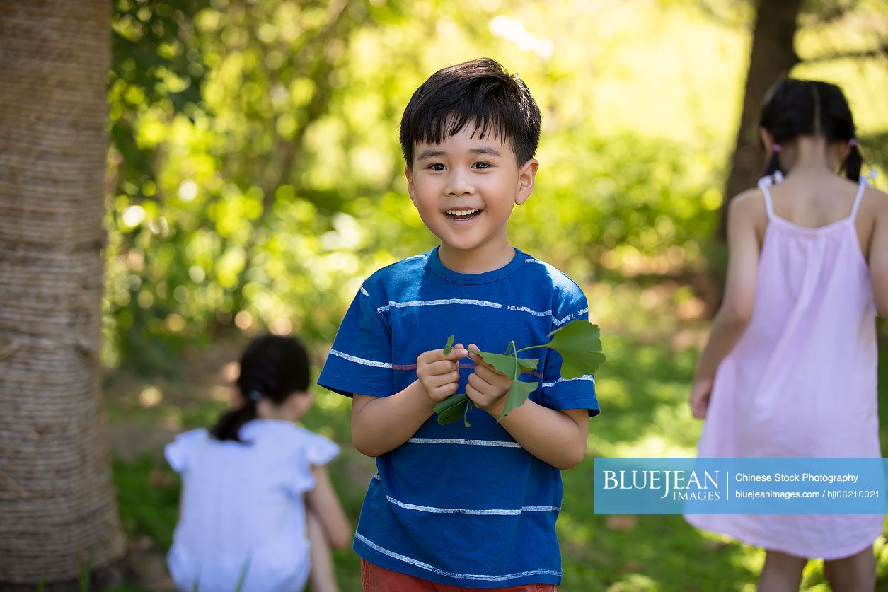 Happy Chinese children playing on meadow