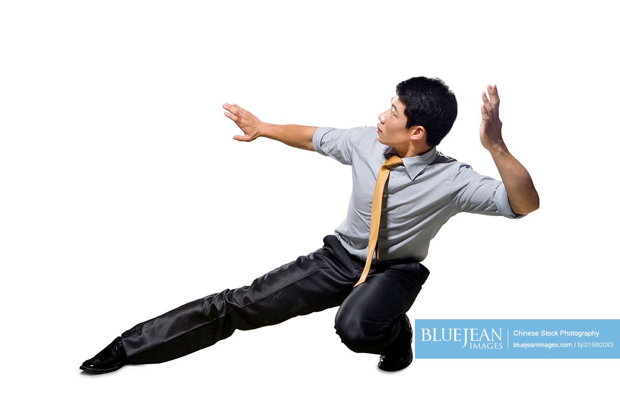 Chinese businessman crouching in martial arts position